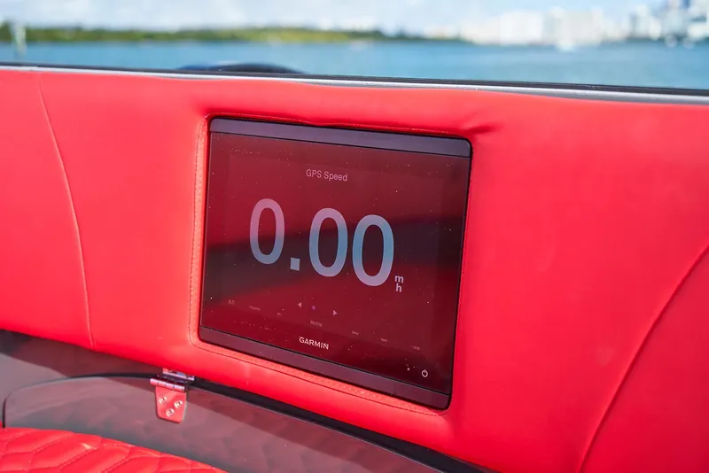 Slide: The Image of Red interior of 2021 Midnight Express 43' Solstice with GPS display showing 0.00 mph. - 15