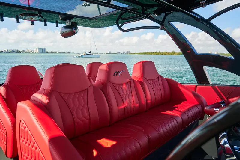 Slide: The Image of Luxurious red seating on 2021 Midnight Express 43' Solstice boat, with scenic ocean view. - 17