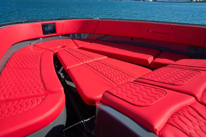 Slide: The Image of Luxurious red seating on 2021 Midnight Express 43' Solstice boat, with ocean backdrop. - 20
