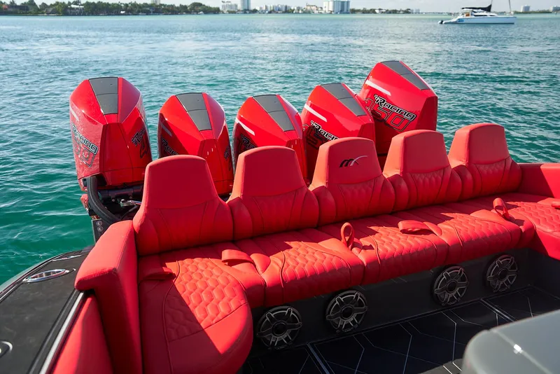Slide: The Image of Red seating and engines on a 2021 Midnight Express 43' Solstice boat, on the water. - 24