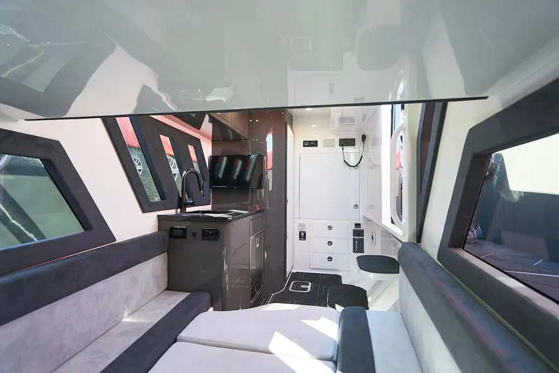 Slide: The Image of Interior of 2021 Midnight Express 43' Solstice boat, featuring modern seating and entertainment area. - 26
