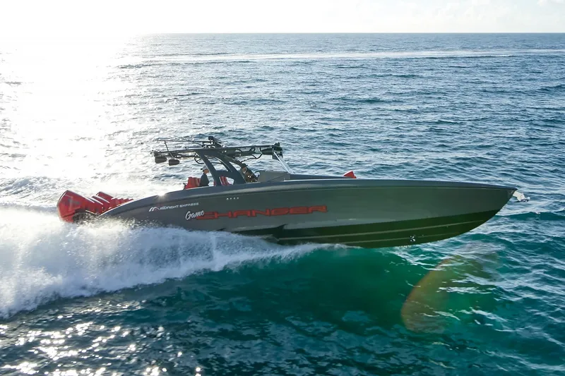 Slide: The Image of 2021 Midnight Express 43' Solstice speedboat cruising on open ocean waters. - 3