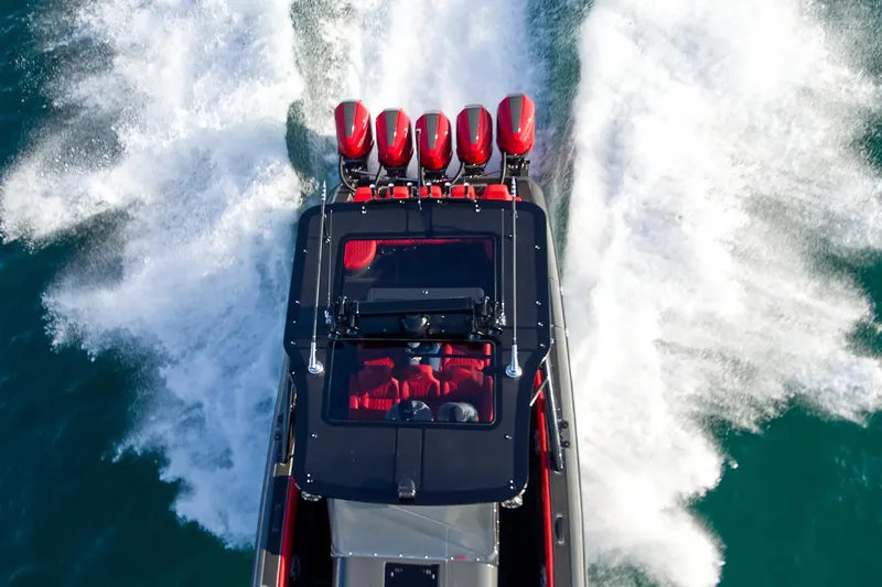 Slide: The Image of Aerial view of 2021 Midnight Express 43' Solstice speedboat with powerful engines on water. - 6