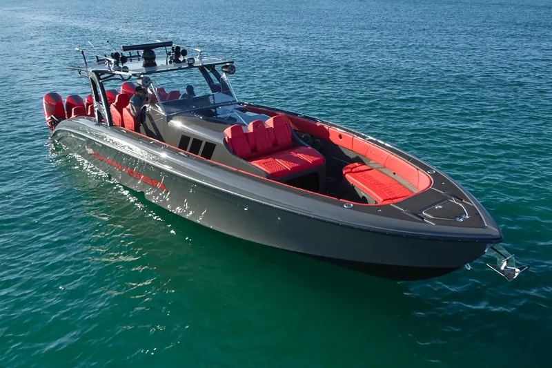 Slide: The Image of 2021 Midnight Express 43' Solstice boat with red seating on clear blue water. - 8