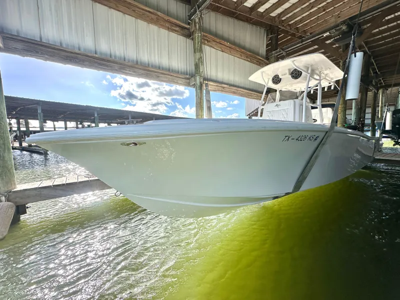 Slide: The Image of 2022 Ocean Runner 29 Center Console boat docked in sunny marina. - 1