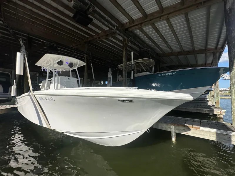 Slide: The Image of 2022 Ocean Runner 29 Center Console boat docked under a covered marina. - 11