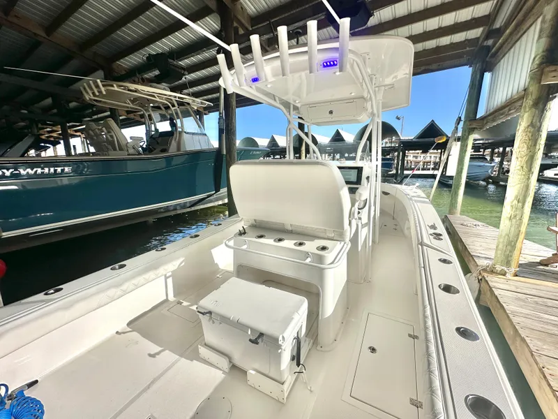 Slide: The Image of 2022 Ocean Runner 29 Center Console boat docked in a marina. - 13