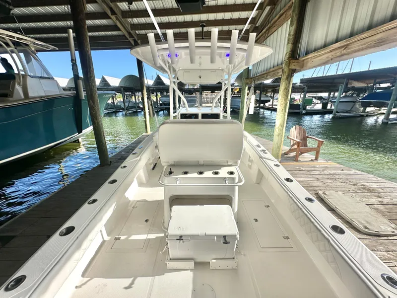 Slide: The Image of 2022 Ocean Runner 29 Center Console boat docked in a marina. - 14