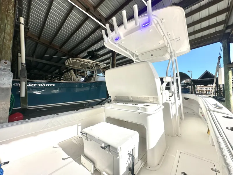 Slide: The Image of 2022 Ocean Runner 29 Center Console boat in a covered dock. - 16