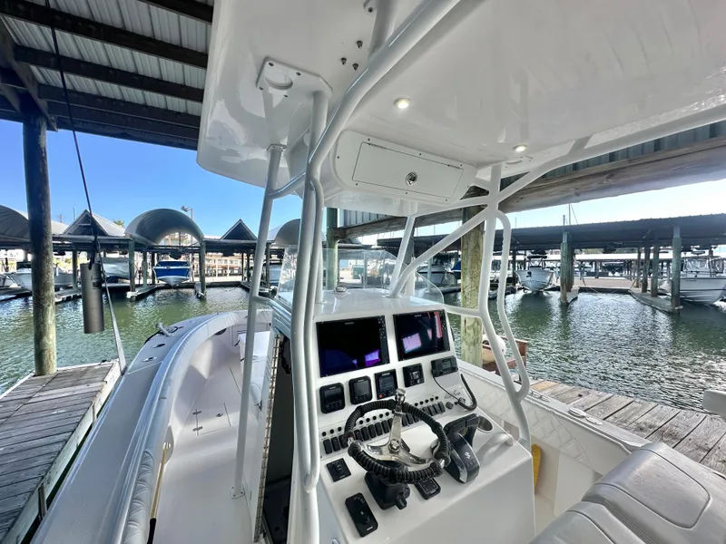Slide: The Image of 2022 Ocean Runner 29 Center Console boat docked at marina. - 18