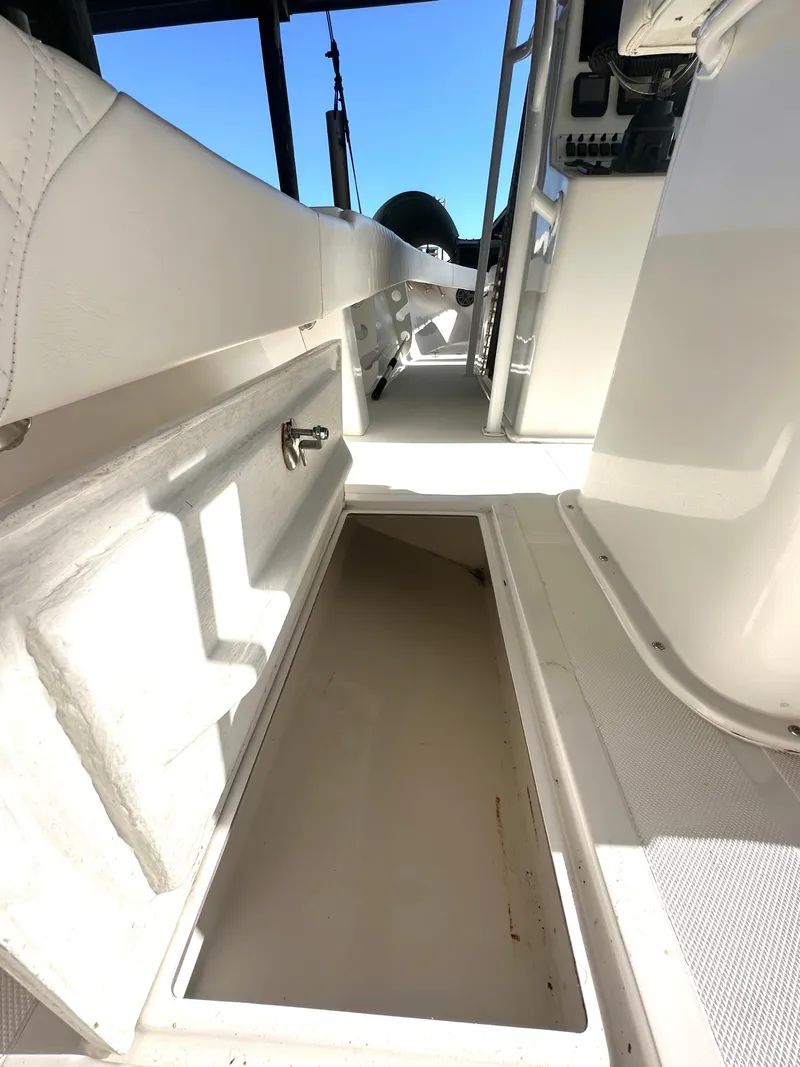 Slide: The Image of 2022 Ocean Runner 29 Center Console interior with storage compartment open. - 22