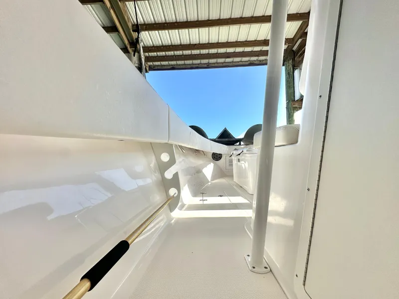 Slide: The Image of 2022 Ocean Runner 29 Center Console boat interior under a metal roof. - 25