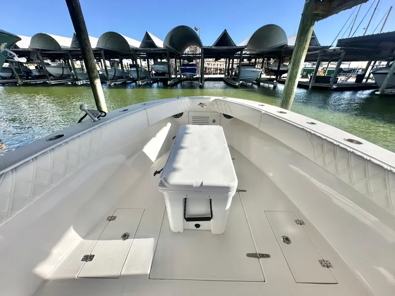 Slide: The Image of 2022 Ocean Runner 29 Center Console boat docked at marina, showcasing spacious deck. - 28