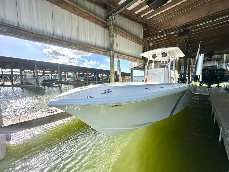 Slide: The Image of 2022 Ocean Runner 29 Center Console boat docked in a marina. - 3