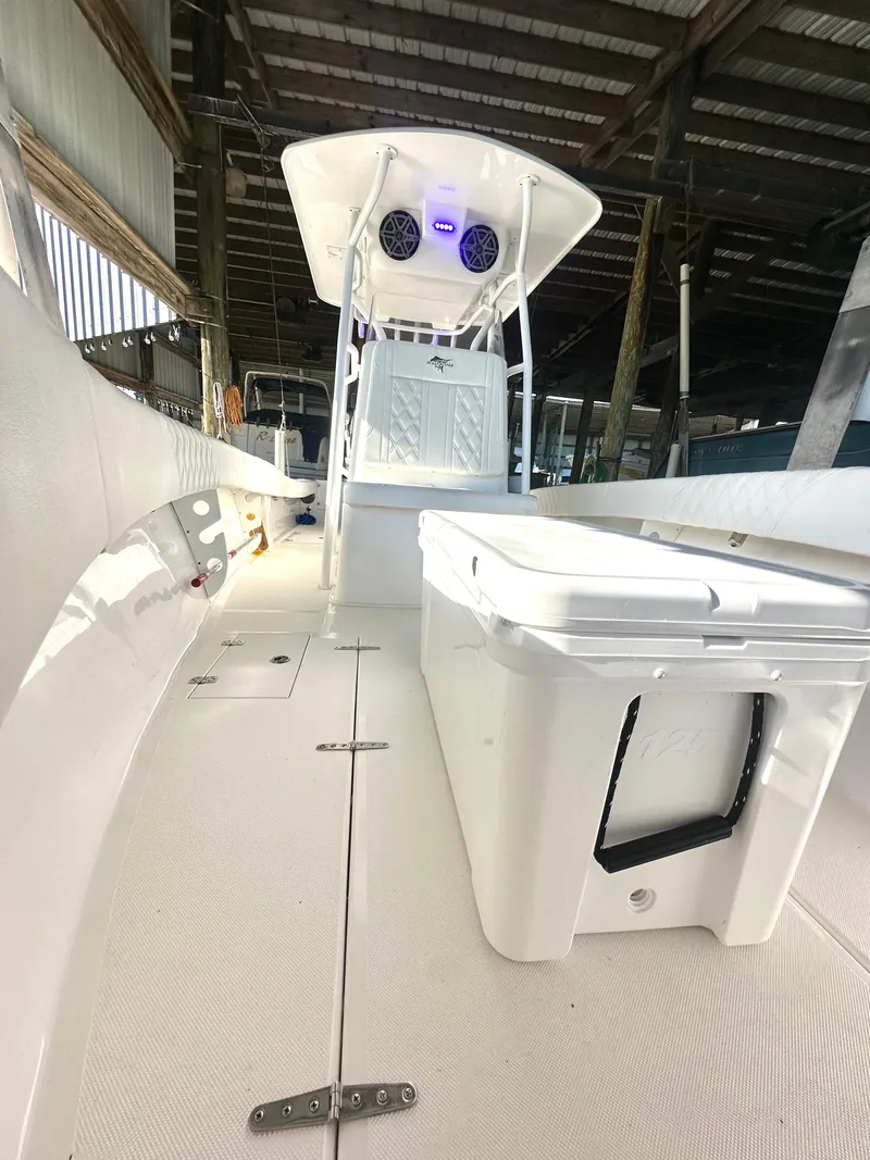 Slide: The Image of 2022 Ocean Runner 29 Center Console boat in a covered dock. - 30