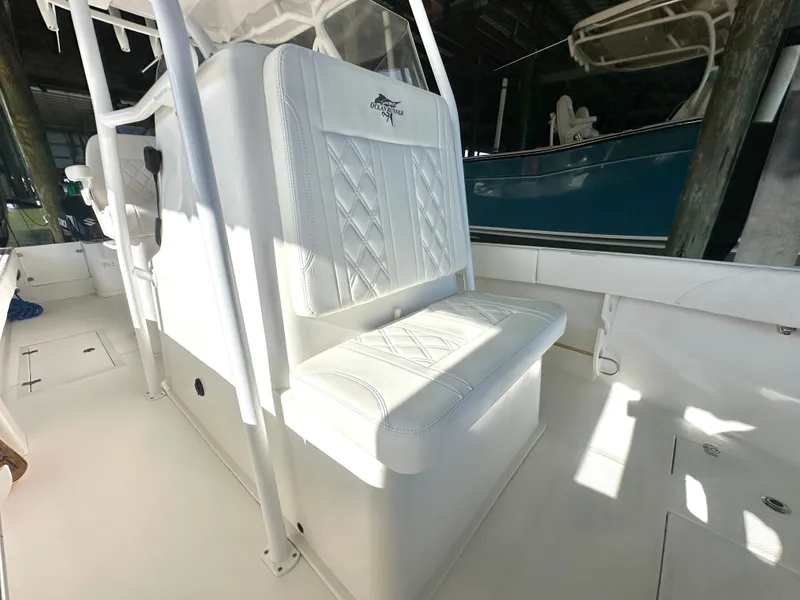 Slide: The Image of 2022 Ocean Runner 29 Center Console boat interior with white seating and console. - 31