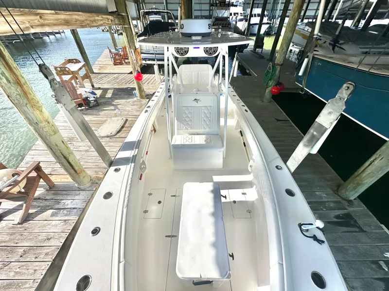 Slide: The Image of 2022 Ocean Runner 29 Center Console boat docked in a marina. - 32