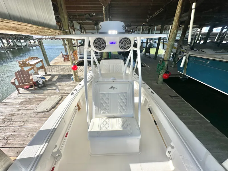 Slide: The Image of 2022 Ocean Runner 29 Center Console boat docked in a covered marina. - 33