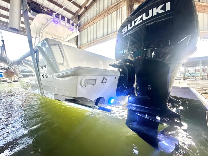 Slide: The Image of 2022 Ocean Runner 29 Center Console with Suzuki outboard engine in a boat lift. - 5