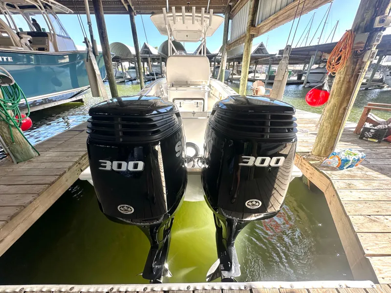 Slide: The Image of 2022 Ocean Runner 29 Center Console with twin 300 horsepower engines docked in marina. - 7