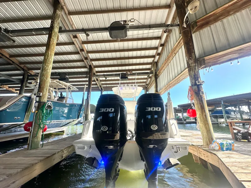 Slide: The Image of 2022 Ocean Runner 29 Center Console with twin 300 HP engines docked in marina. - 8