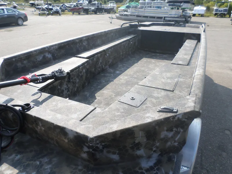 Slide: The Image of 2025 Excel 1854 SWV4 boat with camouflage interior, parked in a marina lot. - 3