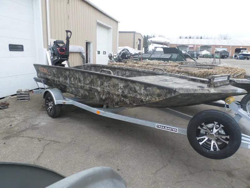 Slide: The Image of 2025 Excel 1754 Eclipse boat on trailer, camo design, parked outdoors. - 1