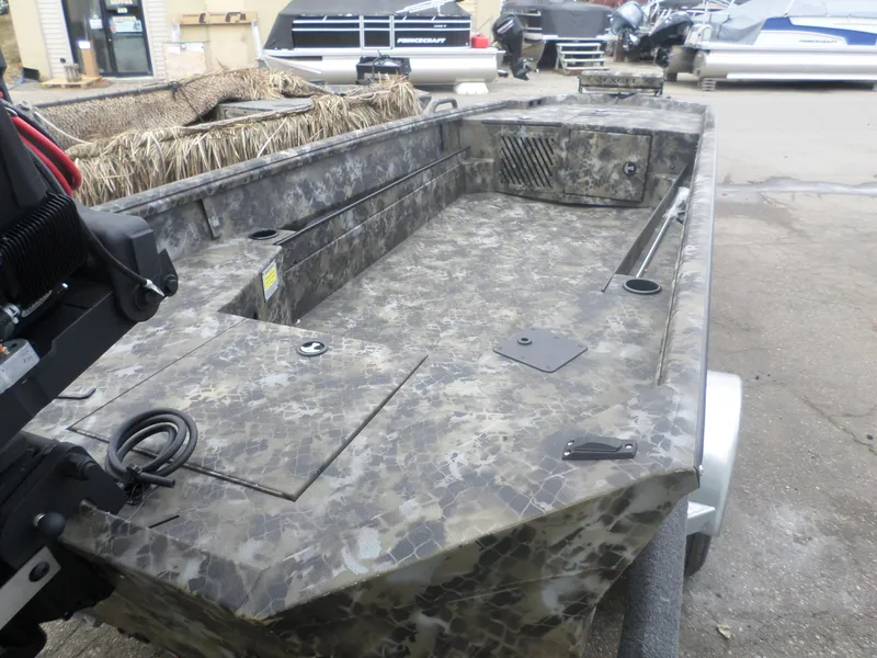 Slide: The Image of 2025 Excel 1754 Eclipse boat with camouflage design, parked outdoors. - 3