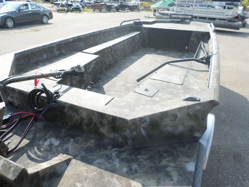 Slide: The Image of 2025 Excel 1860 SWV4 boat with camouflage design in a parking lot. - 4