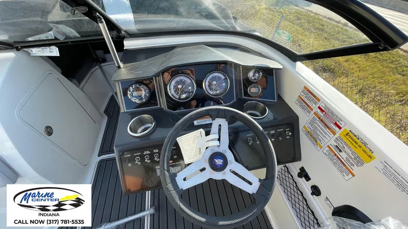 Slide: The Image of 2024 Bayliner VR5 boat dashboard with steering wheel and gauges, Marine Center Indiana contact info. - 11