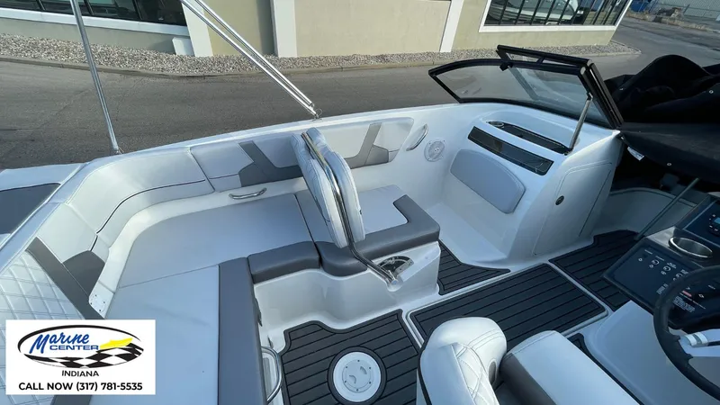 Slide: The Image of 2024 Bayliner VR5 boat interior with modern seating and dashboard, Marine Center contact info visible. - 17