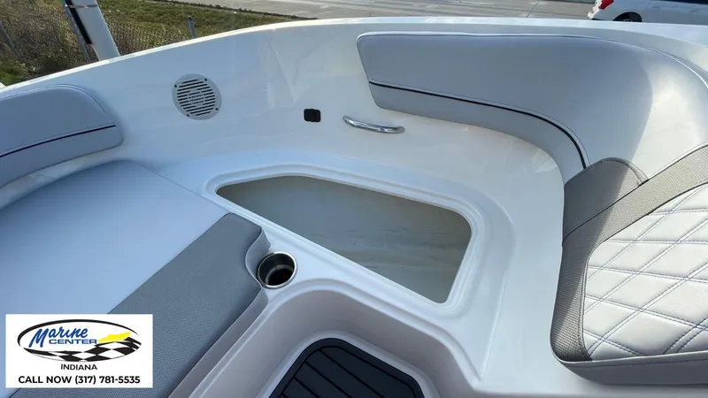 Slide: The Image of 2024 Bayliner VR5 boat interior with seating, storage, and cup holder. - 18