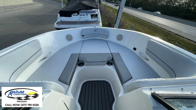 Slide: The Image of 2024 Bayliner VR5 boat interior with seating and cup holders, displayed at Marine Center Indiana. - 4