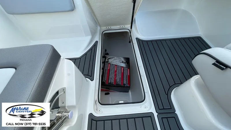 Slide: The Image of 2024 Bayliner VR5 boat interior with storage compartment and Marine Center logo. - 5
