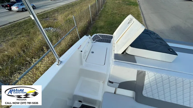 Slide: The Image of 2024 Bayliner VR5 boat deck with storage compartment, Marine Center Indiana contact info visible. - 11