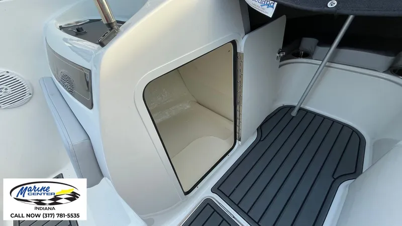 Slide: The Image of 2024 Bayliner VR5 boat interior with open storage compartment and Marine Center logo. - 12