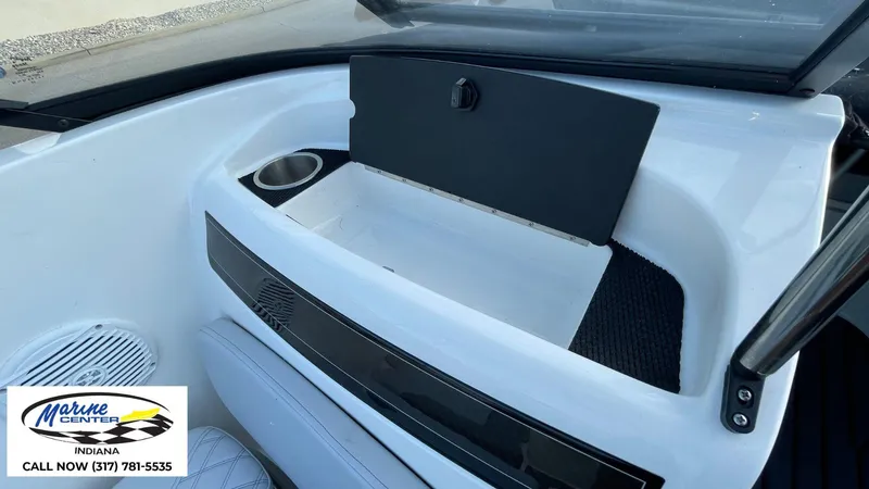 Slide: The Image of 2024 Bayliner VR5 boat interior with storage compartment and cup holder. - 14