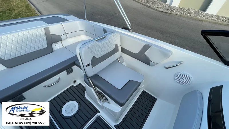 Slide: The Image of 2024 Bayliner VR5 boat interior with gray and white seating, Marine Center Indiana logo. - 4