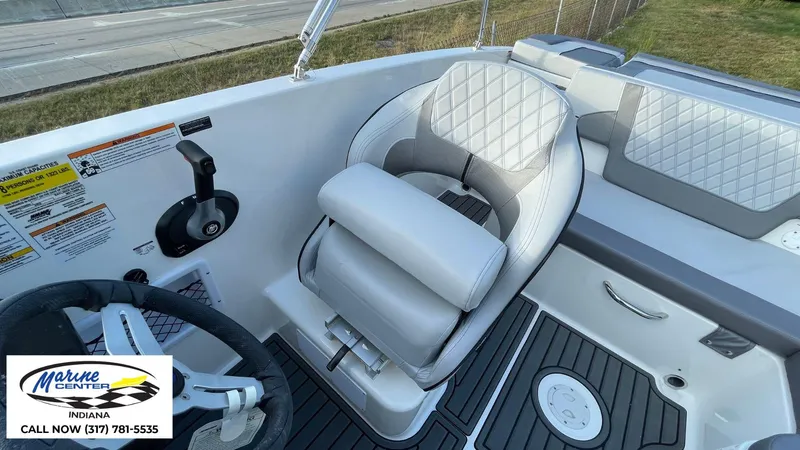Slide: The Image of 2024 Bayliner VR5 boat interior with steering wheel and cushioned seating. - 8