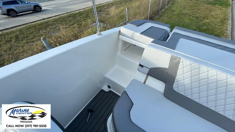 Slide: The Image of 2024 Bayliner VR5 boat interior with gray and white seating, Marine Center contact info visible. - 9