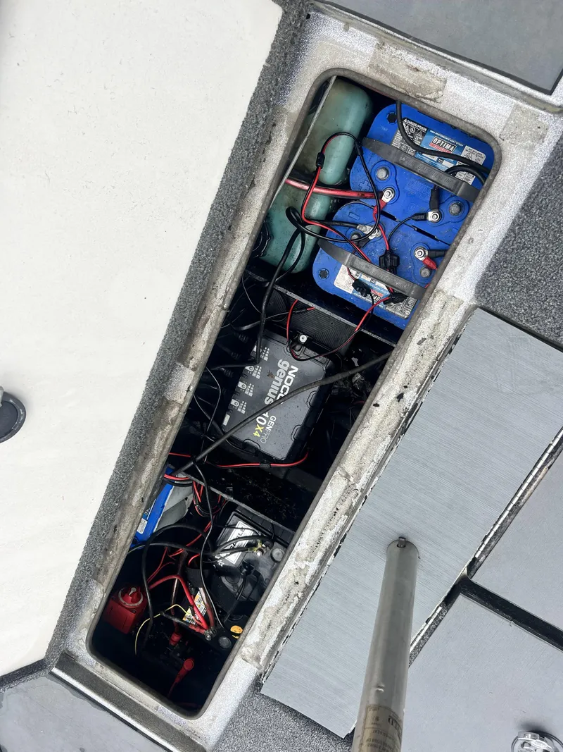 Slide: The Image of Boat battery compartment of a 2009 Ranger 208 VX with multiple batteries and wiring. - 14
