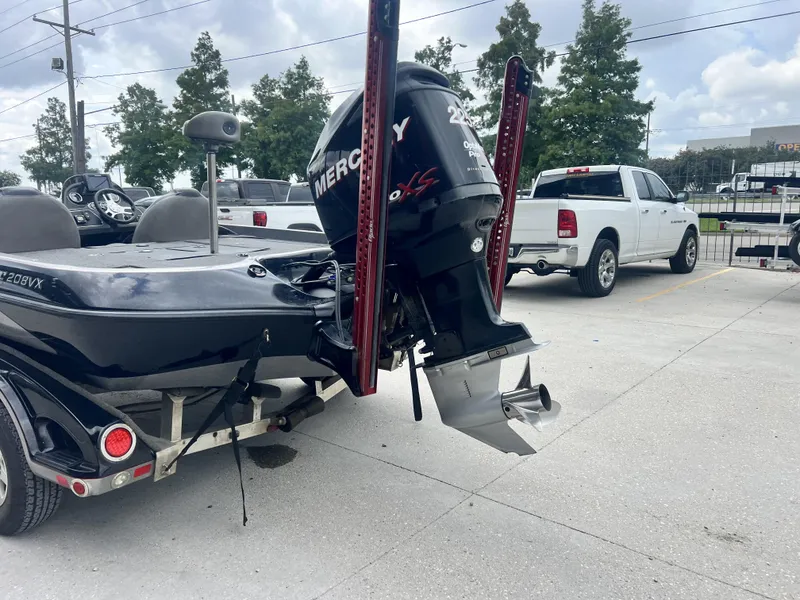 Slide: The Image of 2009 Ranger 208 VX boat with Mercury outboard motor in parking lot. - 16