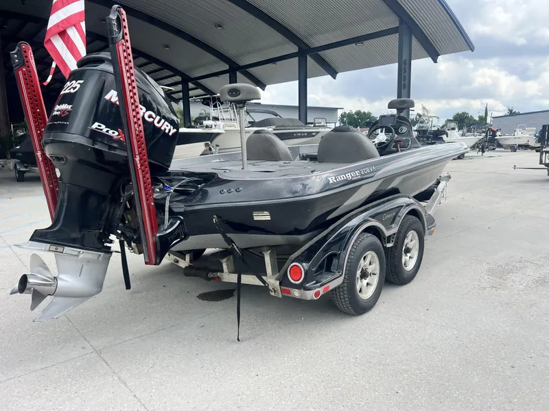 Slide: The Image of 2009 Ranger 208 VX boat with Mercury engine on trailer, parked outdoors. - 18
