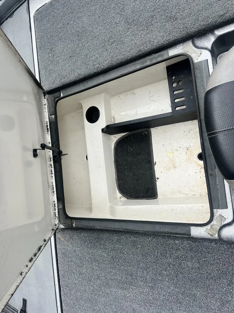 Slide: The Image of Open storage compartment in 2009 Ranger 208 VX boat, featuring carpeted interior. - 19