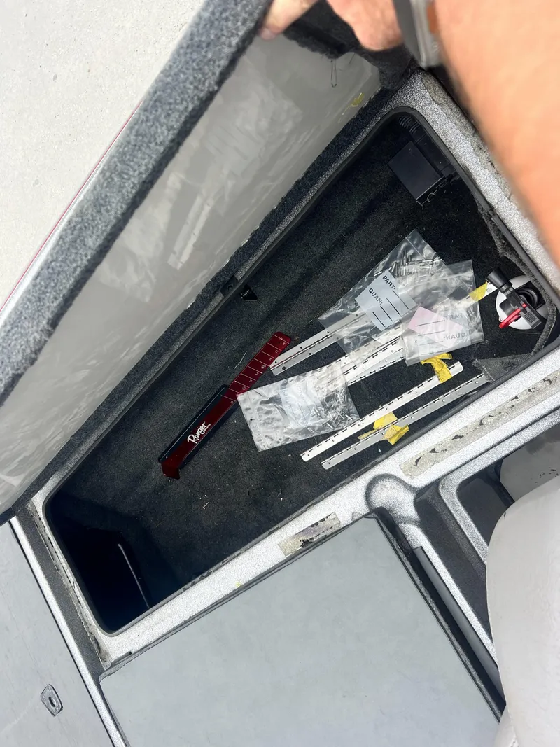 Slide: The Image of Open storage compartment in 2009 Ranger 208 VX boat with fishing gear. - 20
