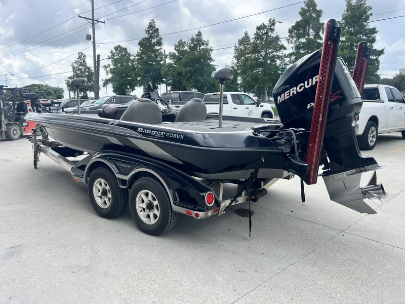 Slide: The Image of 2009 Ranger 208 VX boat with Mercury engine in parking lot. - 5