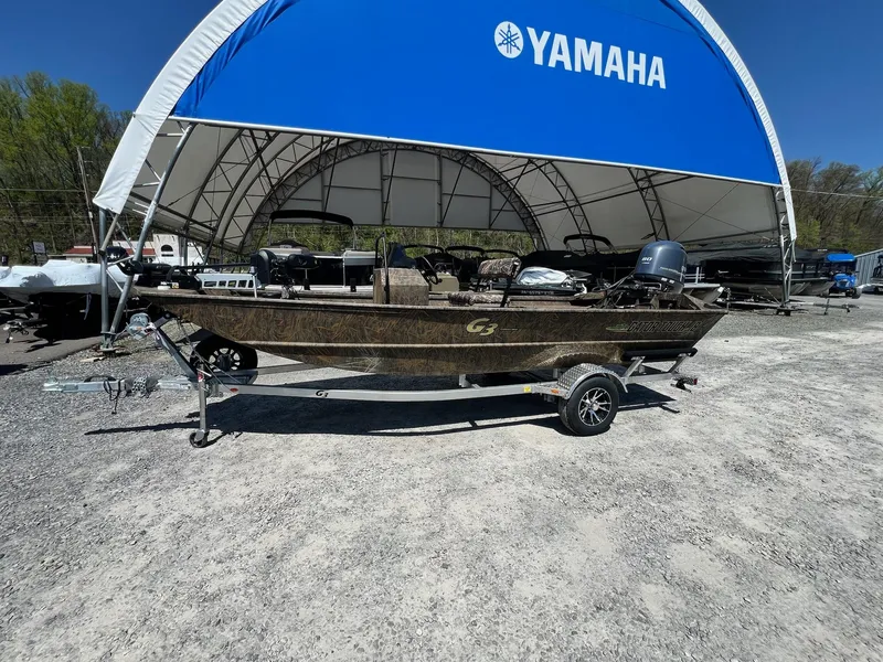 Slide: The Image of 2025 G3 Gator Tough 18 CCJ boat on trailer under Yamaha canopy. - 12