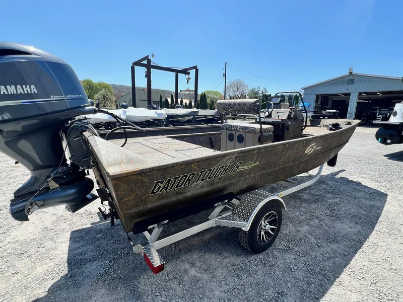 Slide: The Image of 2025 G3 Gator Tough 18 CCJ boat on trailer, featuring Yamaha outboard motor. - 13