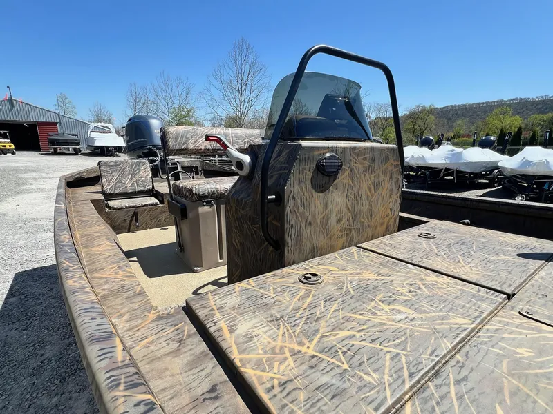 Slide: The Image of 2025 G3 Gator Tough 18 CCJ boat with camouflage design, parked outdoors. - 26