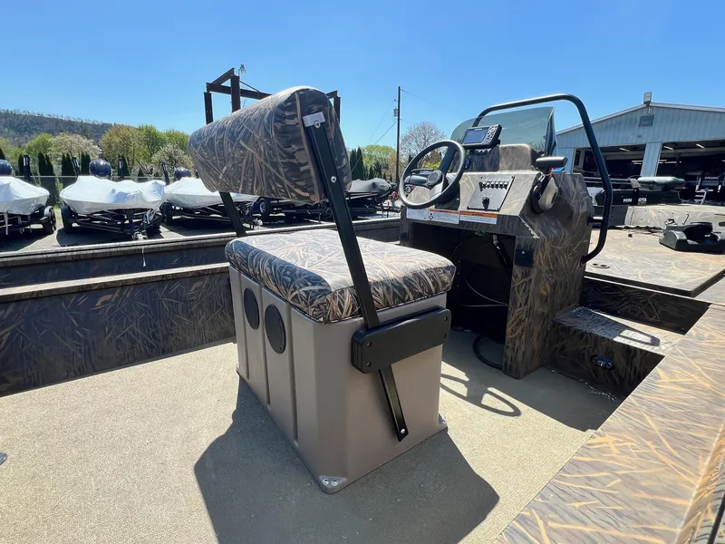 Slide: The Image of 2025 G3 Gator Tough 18 CCJ boat interior with camo seating and steering console. - 7